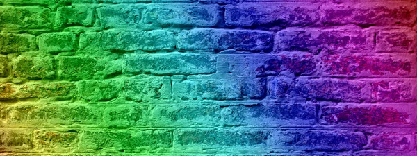 Concept or conceptual colorful painted or old vintage grungy brick wall texture or urban background banner