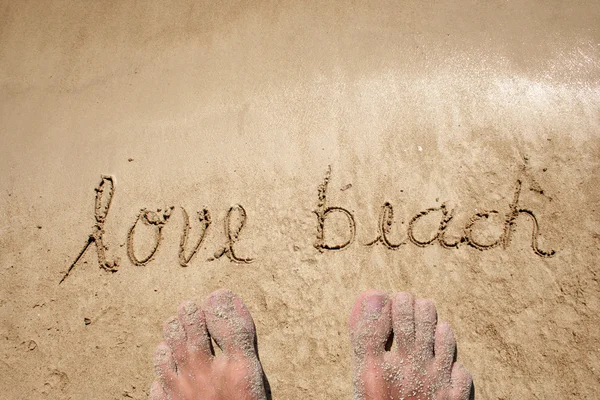 Conceptual hand made or handwritten text in sand