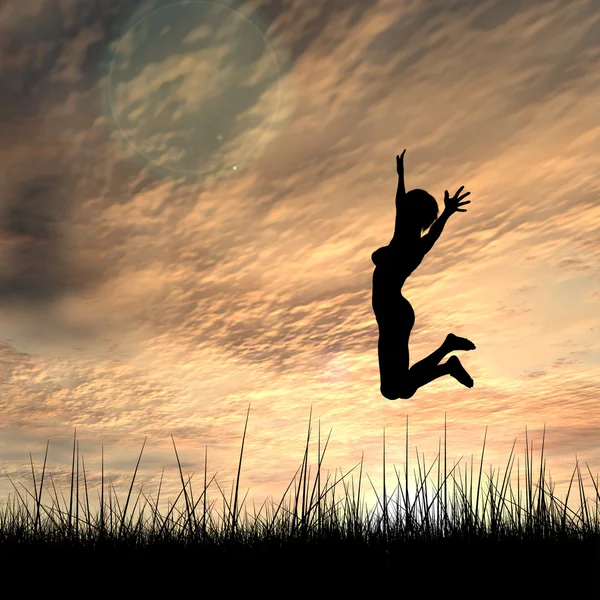 Concept or conceptual young woman or businesswoman silhouette jump happy on grass field at sunset or sunrise sky background