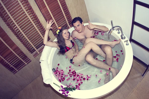 Honeymoon. Newlyweds in hotel in a jacuzzi