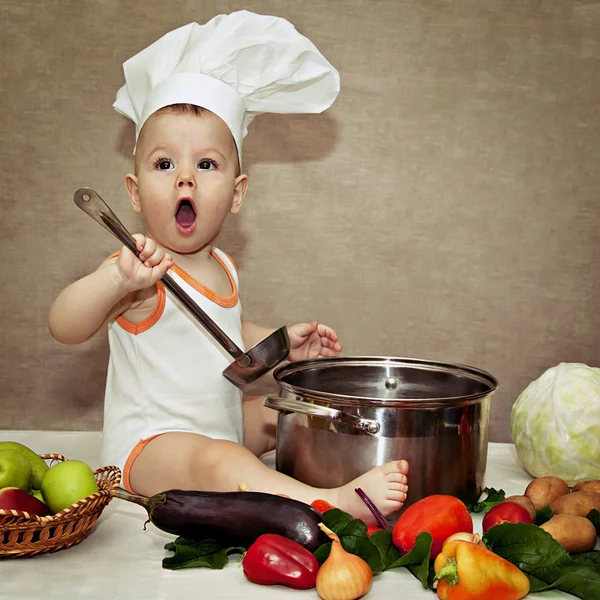 Little baby in a chef\'s hat and ladle in hand