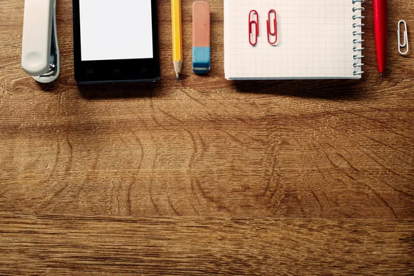 Office Supplies and Phone on Table at Top Edge