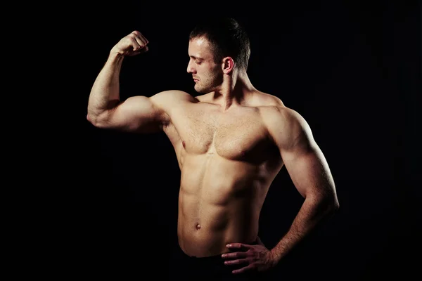 Well trained body of hot guy on black background