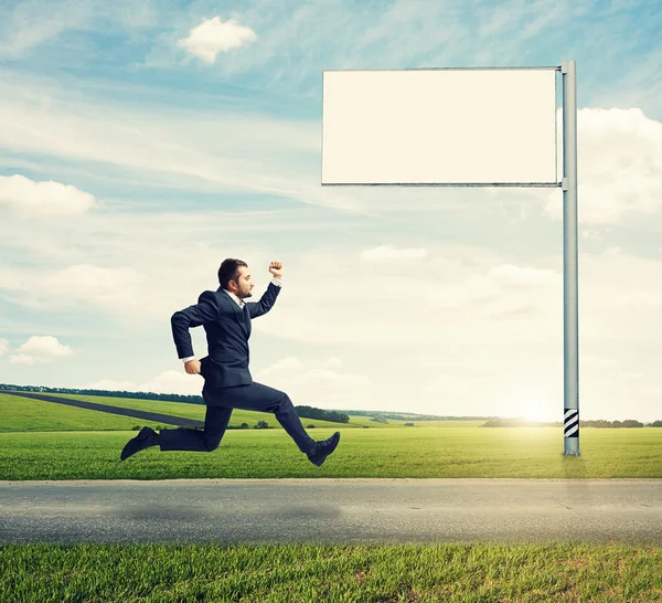 Man in suit running fast on the road