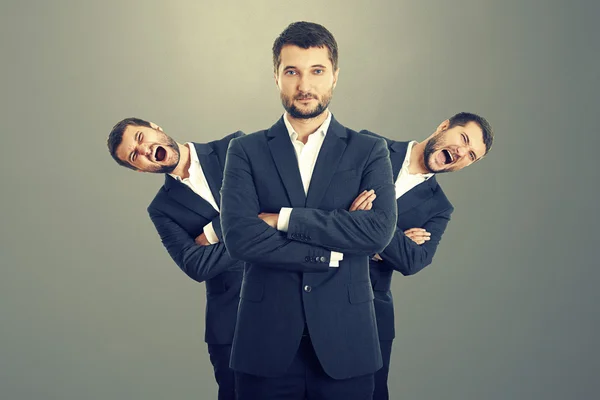 Screaming men behind confident businessman