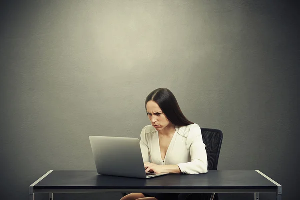 Serious woman with laptop