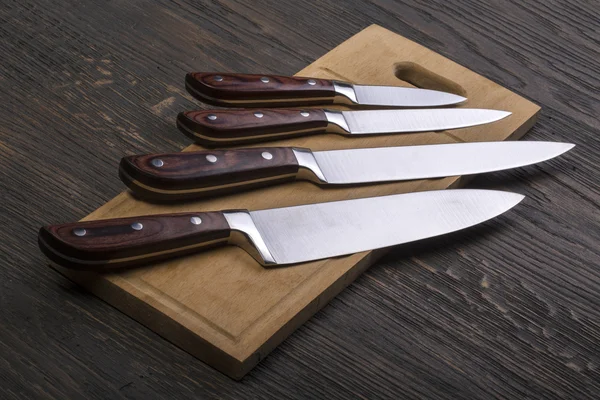 Set of kitchen knifes on wooden