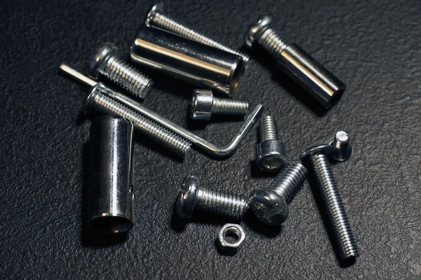 Nuts and bolts on a black background