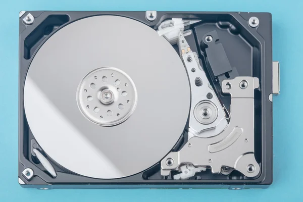 Real open computer hard drive on a blue background