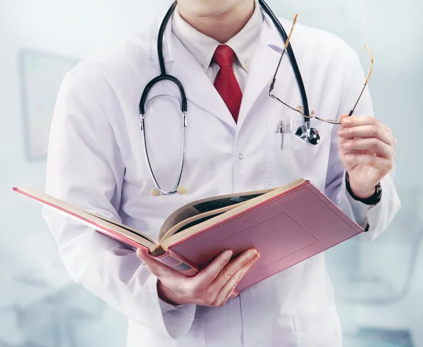 Doctor with stethoscope and book in a hospital