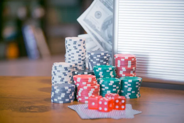 Poker set in a metallic case with lot of money over wooden table, retro filtered image