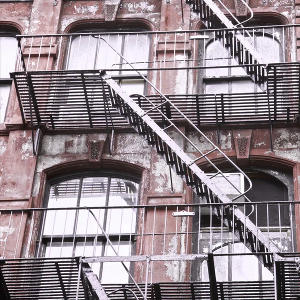 Weathered building with fire escape stairs