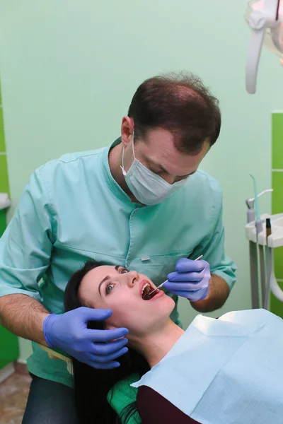 People, medicine, stomatology and health care concept - close up of dentists and assistant with mirror