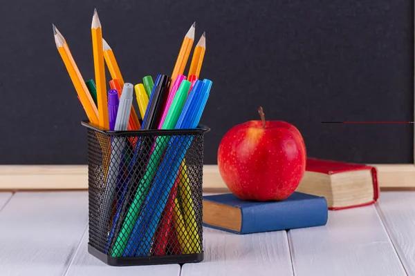 Background blackboard chalk, books, pencils and apple