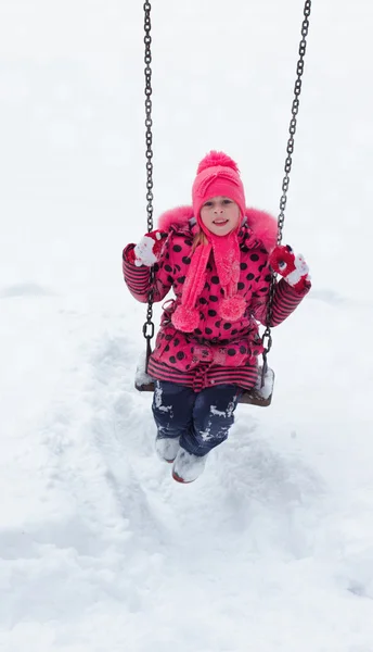 Little girl playing in a snow pile.