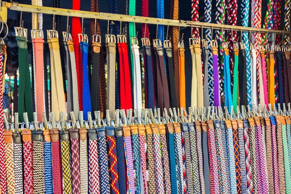 Many belts of all types and colors