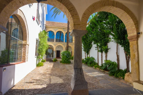 Typical Andalusian courtyard decorated with flowers arches and c