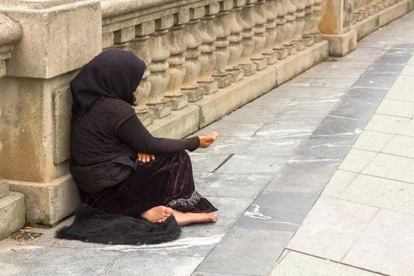 Poor woman begging in the street