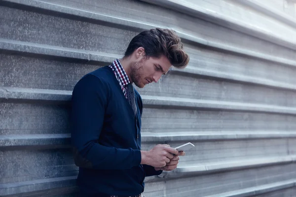 Young businessman texting smartphone phone