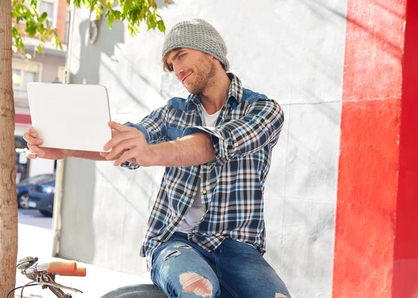 Young man selfie with tablet pc touch in bicycle