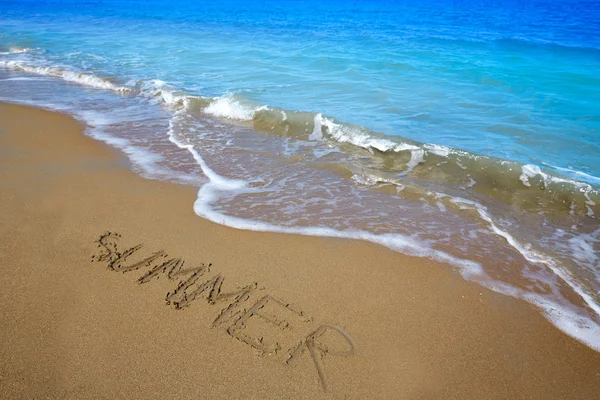 Summer spell written word in sand of a beach