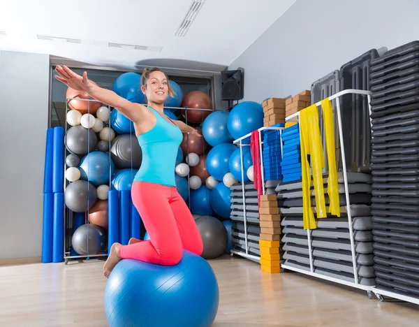 Girl at gym swiss ball knee balance drill exercise