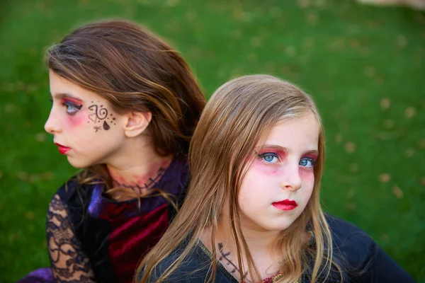 Halloween makeup kid girls blue eyes in outdoor lawn