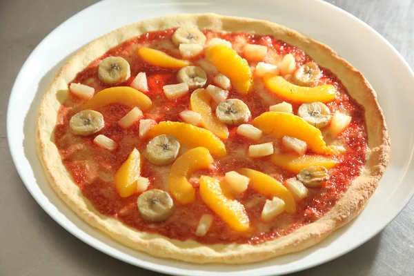 Sweet pizza with banana and orange