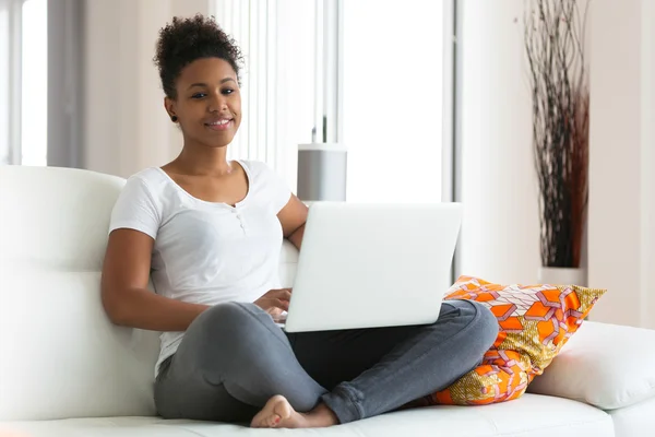 African American student girl using a laptop computer - black pe