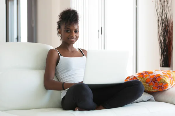 African American student girl using a laptop computer - black pe