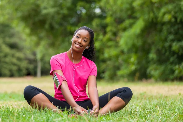 African american woman jogger stretching  - Fitness, people and