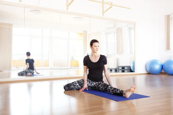 Woman doing yoga at the yoga studio.