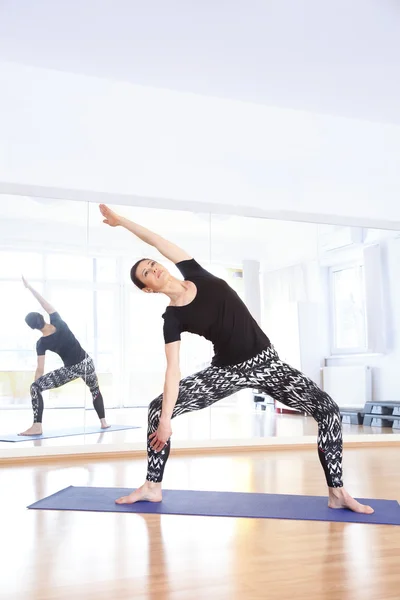 Yoga instructor doing yoga at studio.