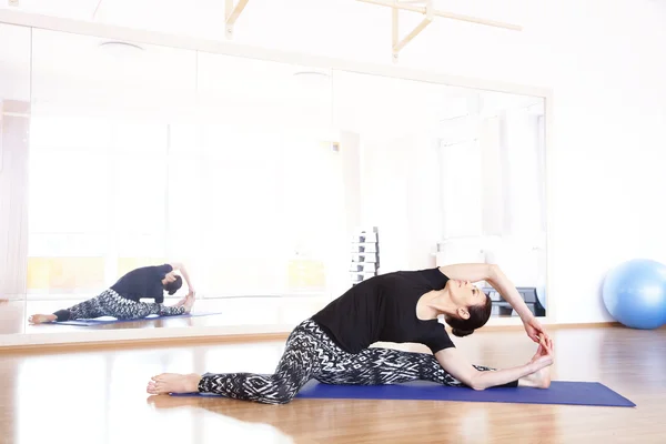 Middle aged woman in yoga pose
