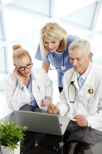 Medical team working at laptop
