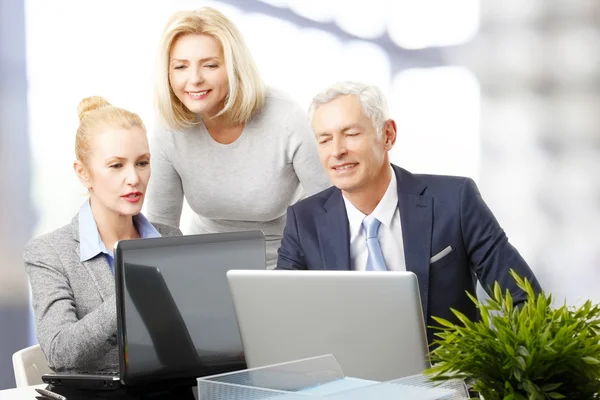 Businessman with women near computer