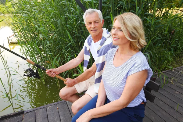 Happy senior couple fishing