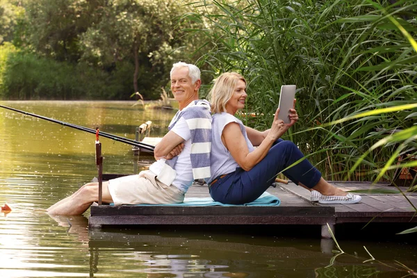Funny senior people with tablet
