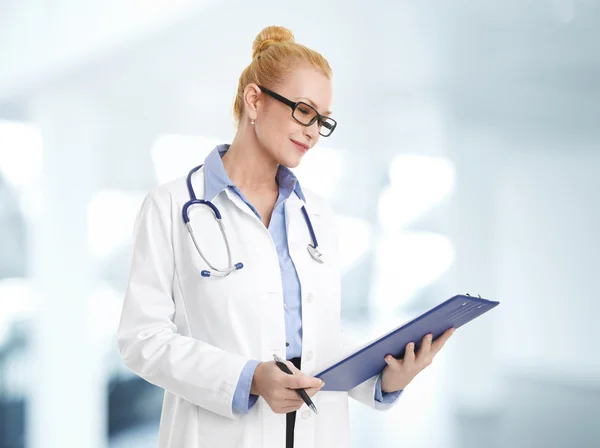 Doctor checking sick list on clipboard