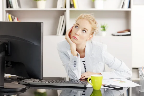 Young businesswoman thinking