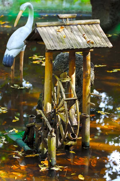 Decorative fountain with bamboo water , pond