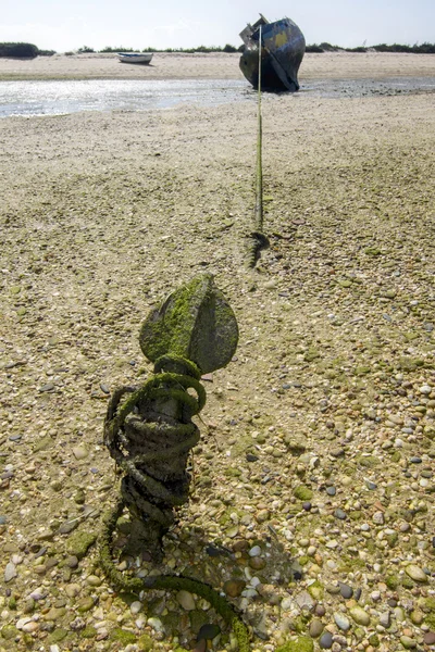 Old abandoned boat stranded on dry sand