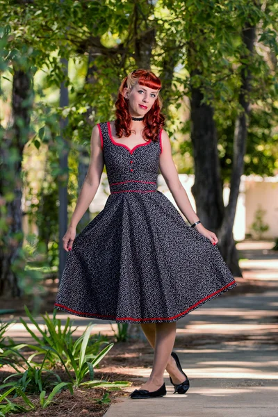 Young woman with a simple spring dress posing on the park