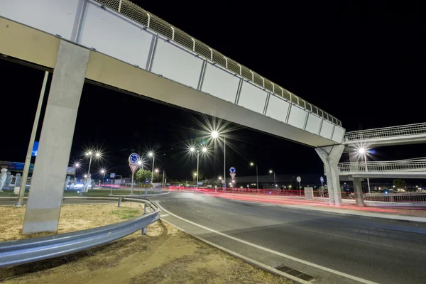 Car streak lights at night near the airport of Faro