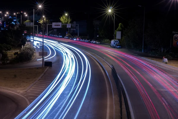 Car streak lights at night near the airport of Faro city