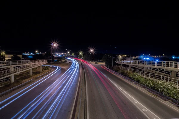 Car streak lights at night near the airport of Faro city