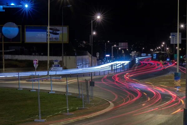 Car streak lights at night near the airport of Faro
