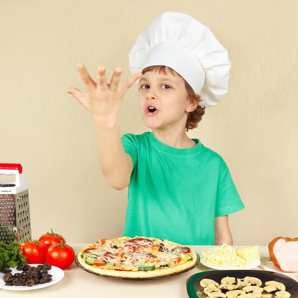Little funny chef expressive enjoys cooked pizza