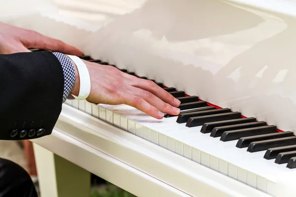 Pianist playing the white piano