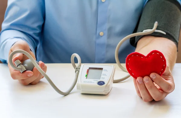 Doctor with digital blood pressure monitor